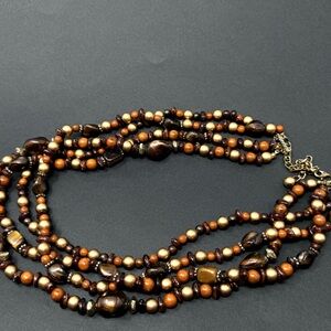Triple strand bead necklace.